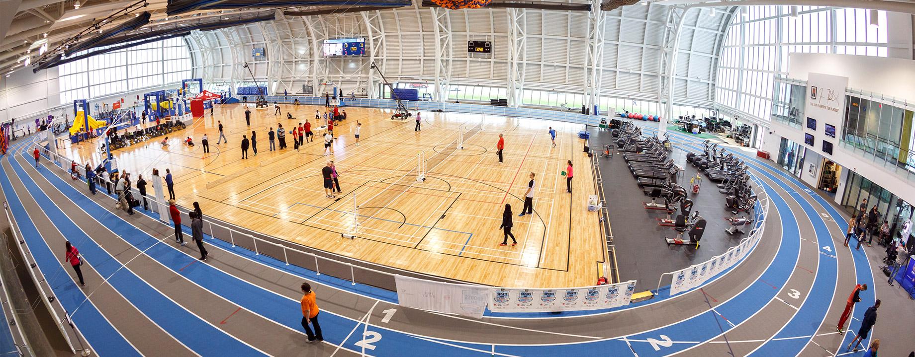 Image of Abilities Centre facility including track with exercise equipment and basketball court.